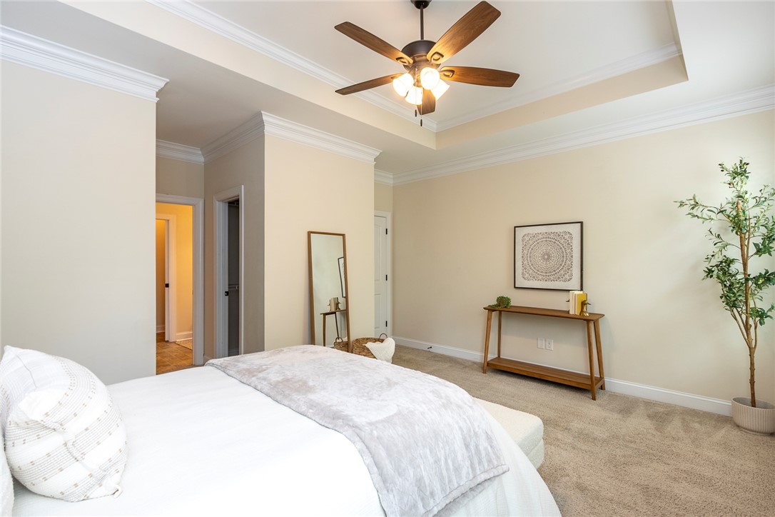 234 Streams Way Anderson, SC 29625 - Photo 26 of 44 This spacious bedroom features elegant crown molding and soft carpeting, creating a tranquil retreat.