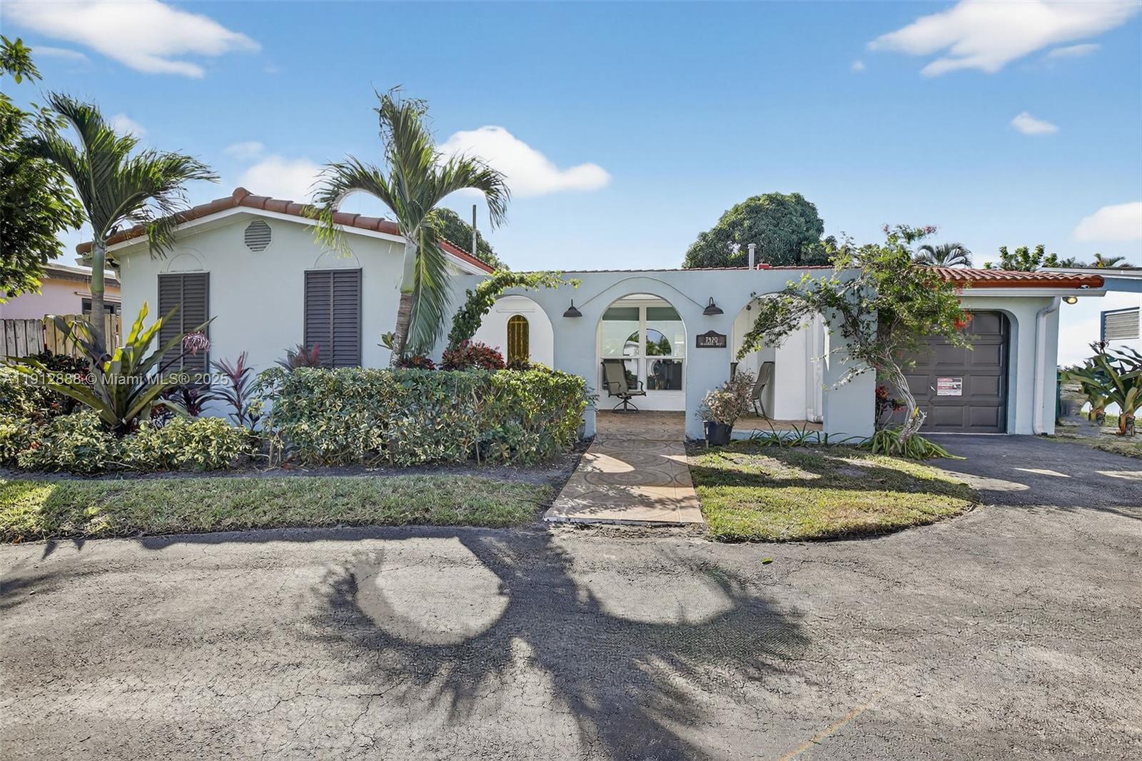 7920 Alhambra Boulevard Miramar, FL 33023 - Photo 1 of 38 a front view of a house with a yard and garage