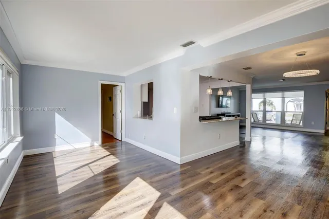 a view of an entryway with wooden floor and door