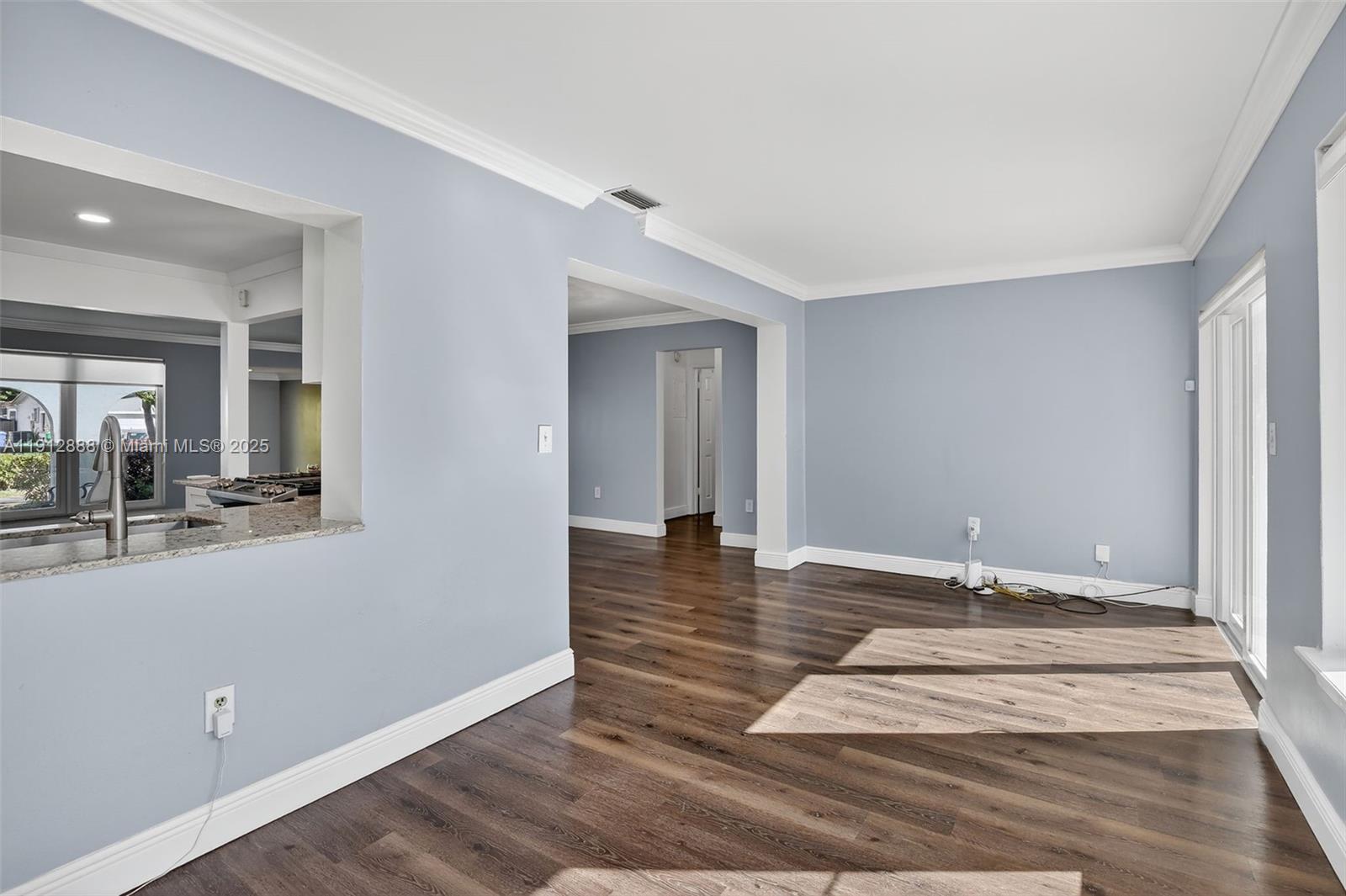 7920 Alhambra Boulevard Miramar, FL 33023 - Photo 14 of 38 a view of a room with wooden floor and furniture