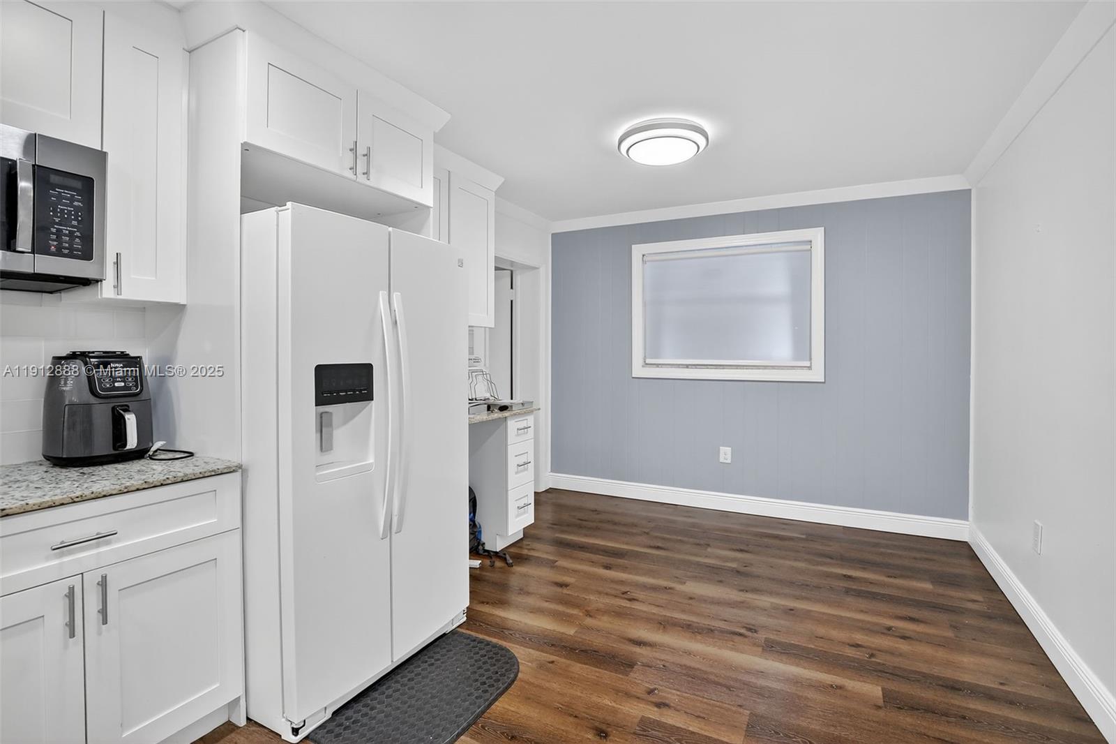 7920 Alhambra Boulevard Miramar, FL 33023 - Photo 18 of 38 a kitchen with white cabinets and white appliances