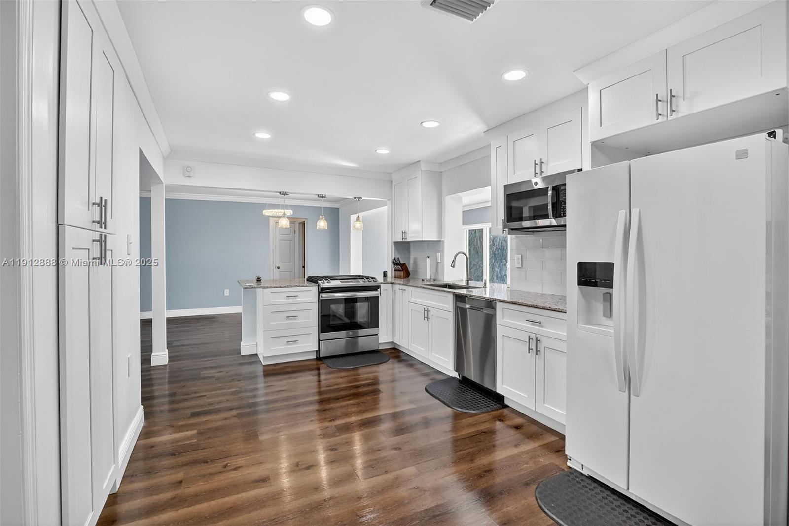 7920 Alhambra Boulevard Miramar, FL 33023 - Photo 19 of 38 a kitchen with stainless steel appliances a refrigerator and a stove top oven