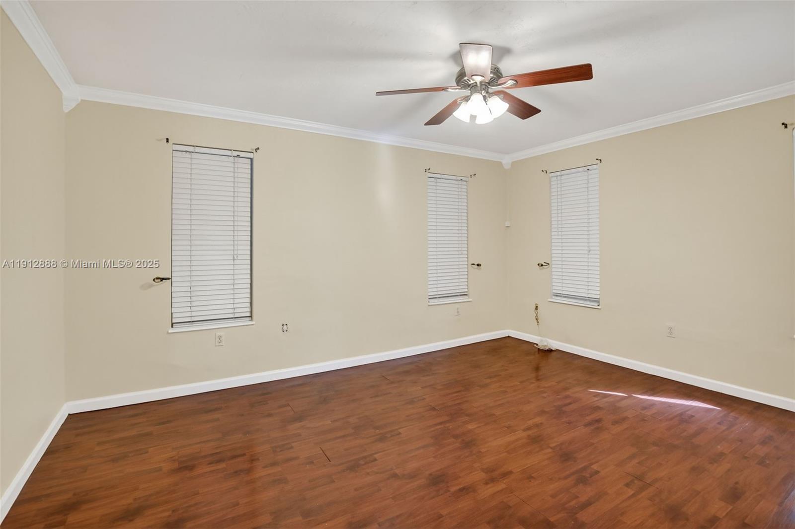 7920 Alhambra Boulevard Miramar, FL 33023 - Photo 20 of 38 an empty room with a ceiling fan and windows