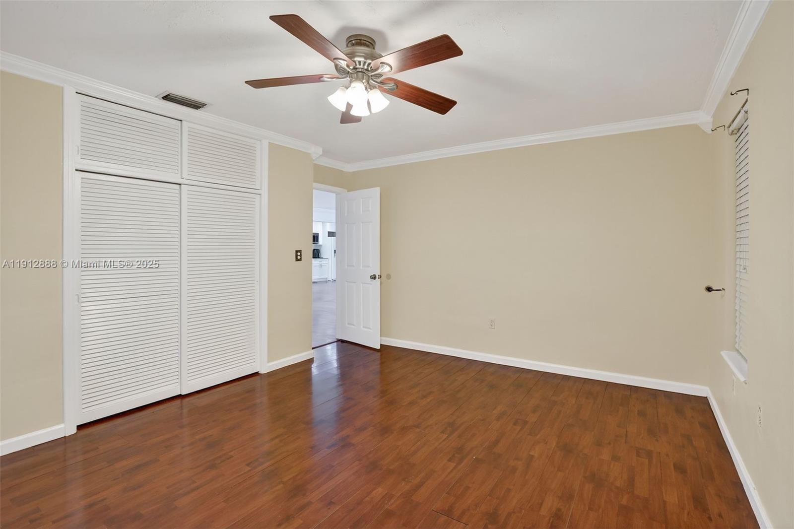 7920 Alhambra Boulevard Miramar, FL 33023 - Photo 23 of 38 an empty room with wooden floor and ceiling fan