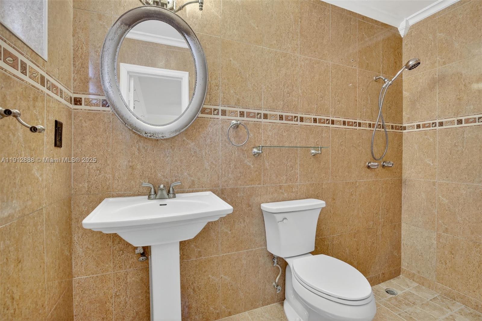 7920 Alhambra Boulevard Miramar, FL 33023 - Photo 25 of 38 a bathroom with a sink a toilet and a mirror