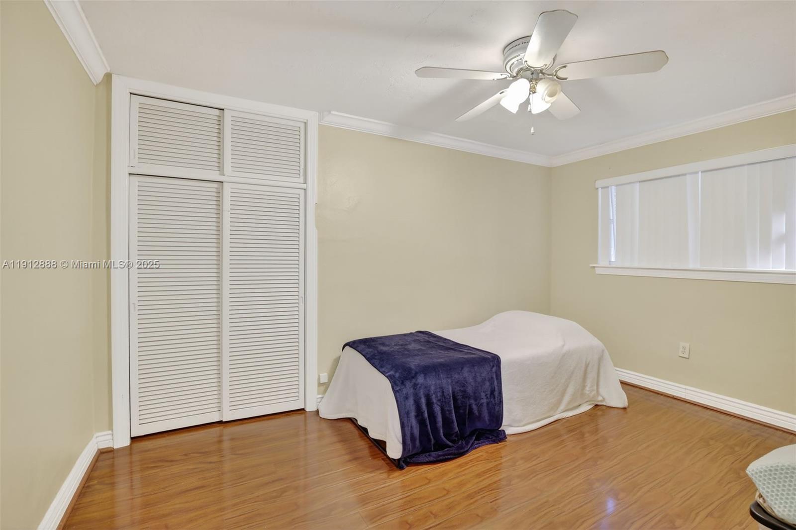 7920 Alhambra Boulevard Miramar, FL 33023 - Photo 26 of 38 a spacious bedroom with a bed and a chandelier