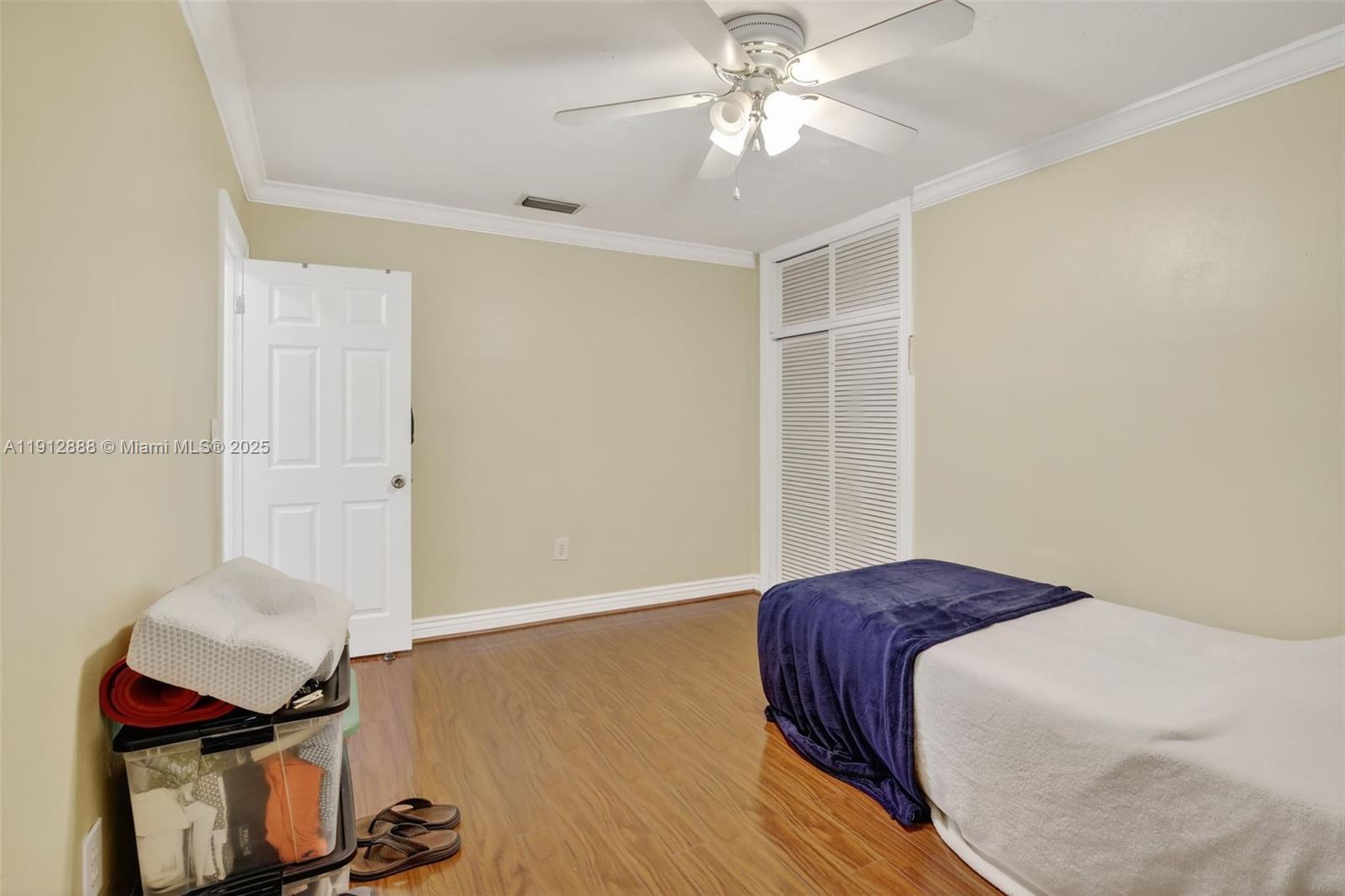 7920 Alhambra Boulevard Miramar, FL 33023 - Photo 28 of 38 a bedroom with a bed and wooden floor