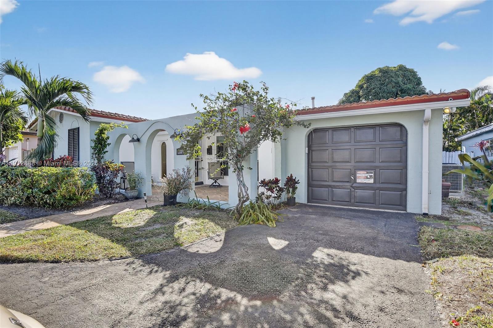 7920 Alhambra Boulevard Miramar, FL 33023 - Photo 3 of 38 a front view of a house with garden