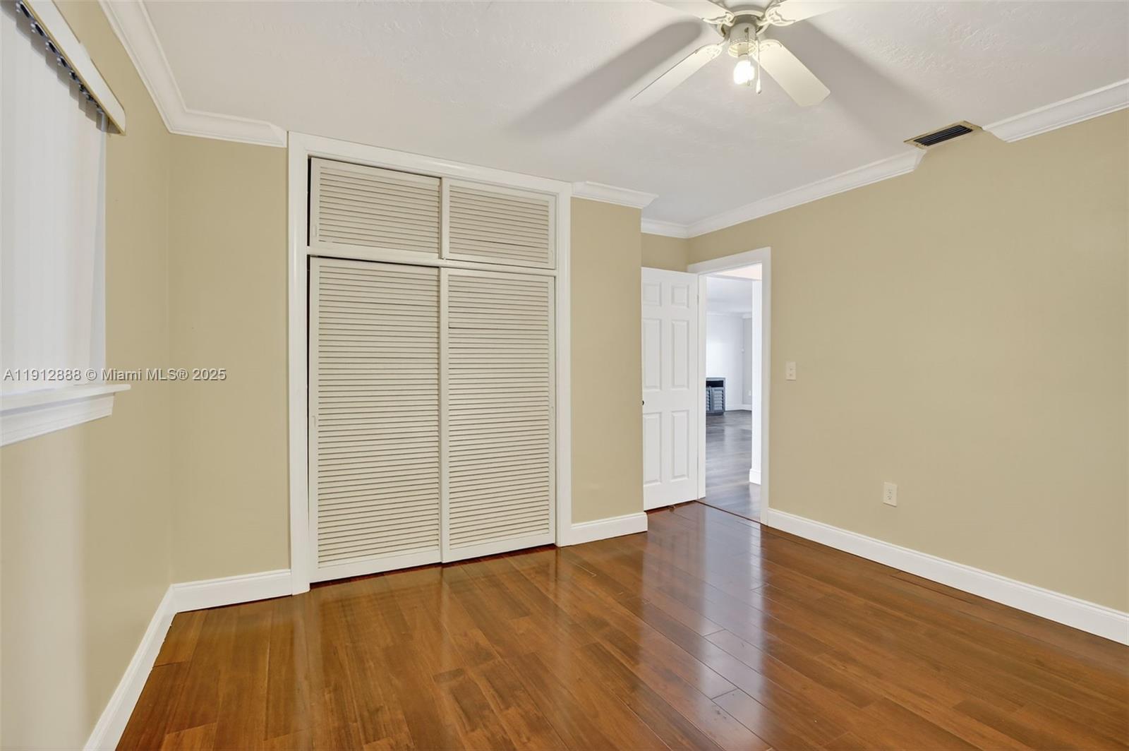 7920 Alhambra Boulevard Miramar, FL 33023 - Photo 32 of 38 an empty room with wooden floor and windows