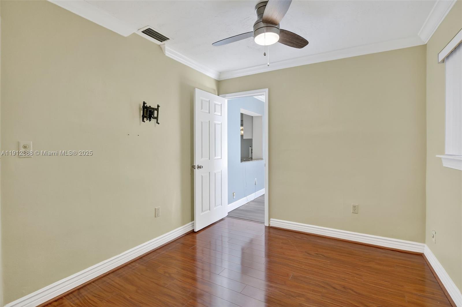 7920 Alhambra Boulevard Miramar, FL 33023 - Photo 34 of 38 wooden floor in an empty room with a window