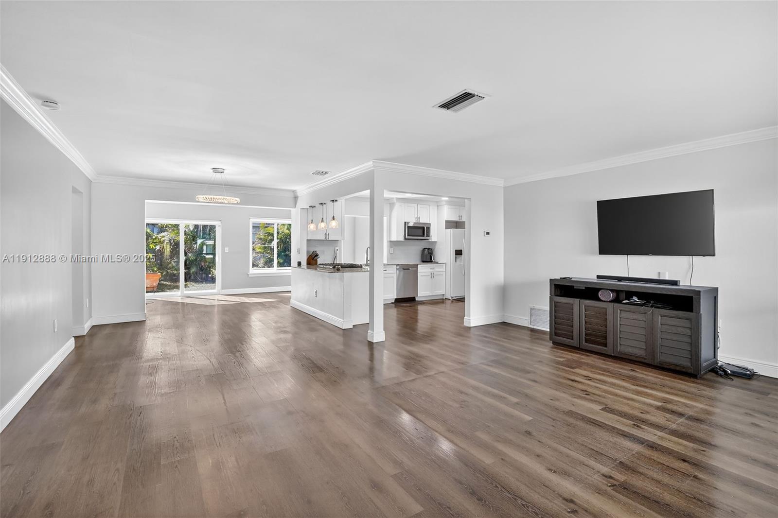 7920 Alhambra Boulevard Miramar, FL 33023 - Photo 5 of 38 a view of a living room hardwood floor and a kitchen