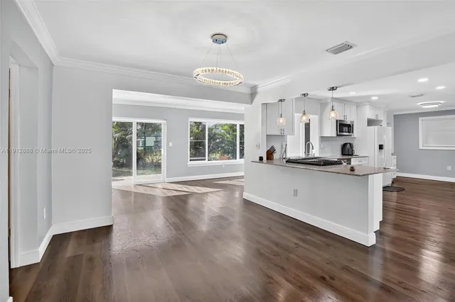 a view of kitchen with sink and wooden floor