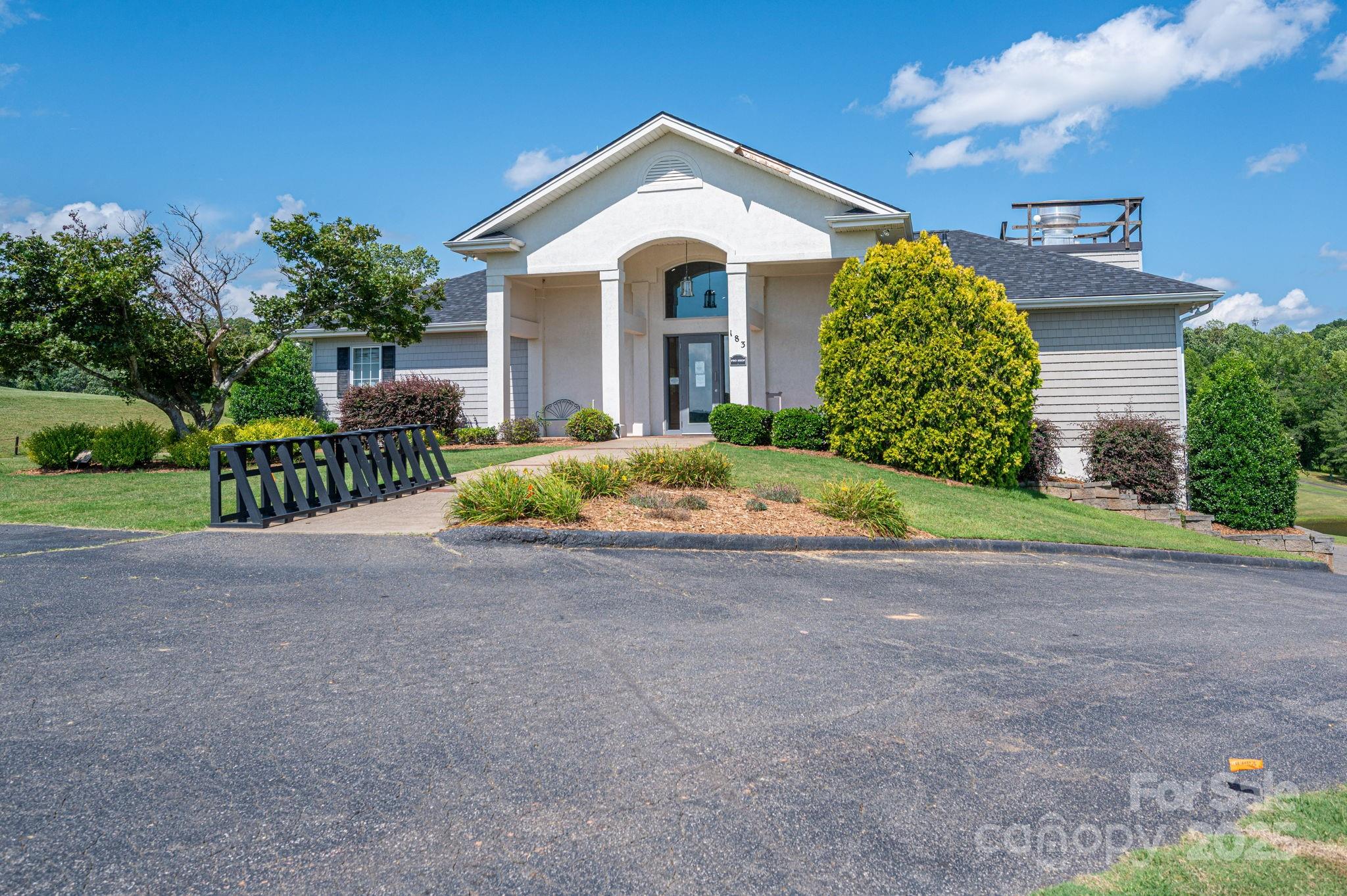 Lot 219 Plantation Drive Rutherfordton, NC 28139 - Photo 10 of 19 a front view of a house with a garden