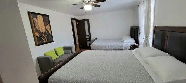 a bedroom with a bed and a couch