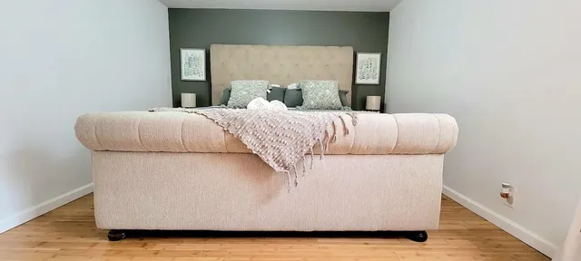 a bedroom with a bed and a night stand