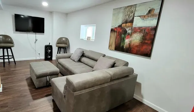 a living room with furniture and a flat screen tv