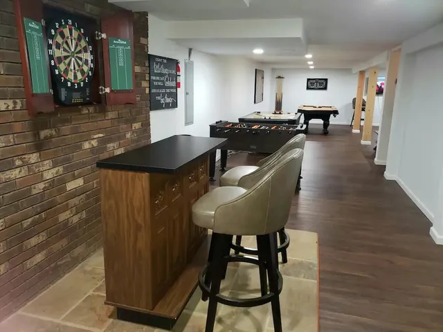 a kitchen with granite countertop a table and chairs in it