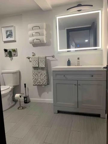 a spacious bathroom with a sink a mirror and a bathtub