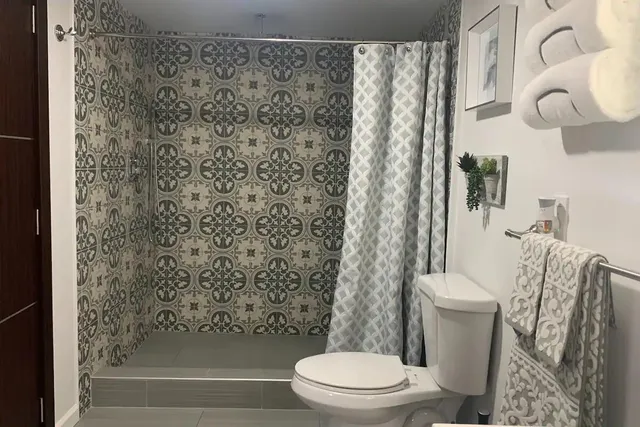 a bathroom with a toilet and a shower