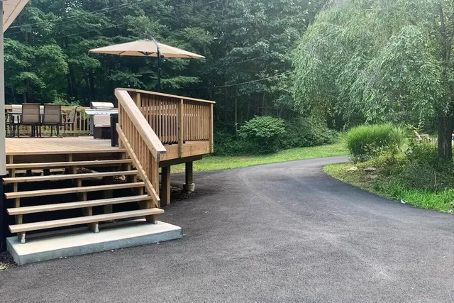 a view of backyard with small cabin and a chair