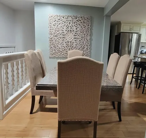 a view of a workspace with furniture and wooden floor