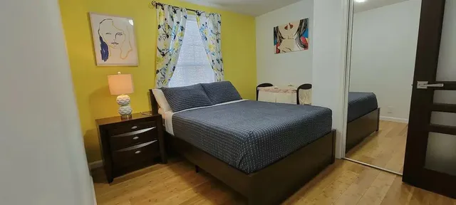 a bedroom with a bed and cupboard