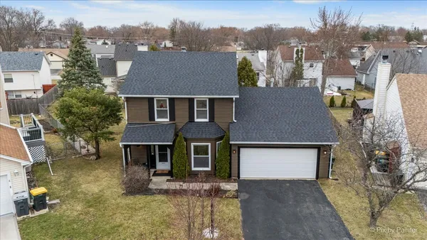 a aerial view of a house with a yard