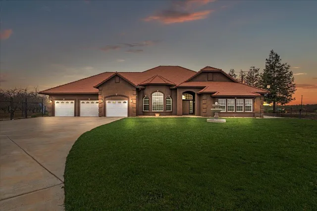 a front view of a house with garden