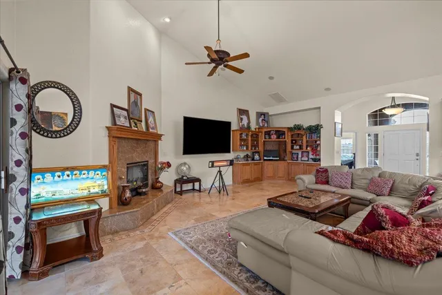 a living room with fireplace furniture and a flat screen tv