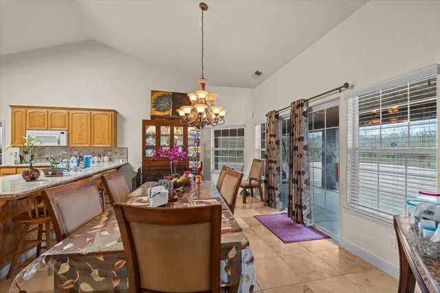 a large kitchen with sink refrigerator and microwave
