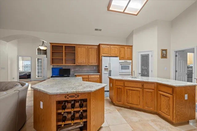 a living room with furniture a flat screen tv and a dining table