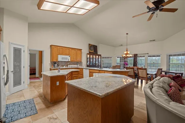 a kitchen with a sink a counter and chairs