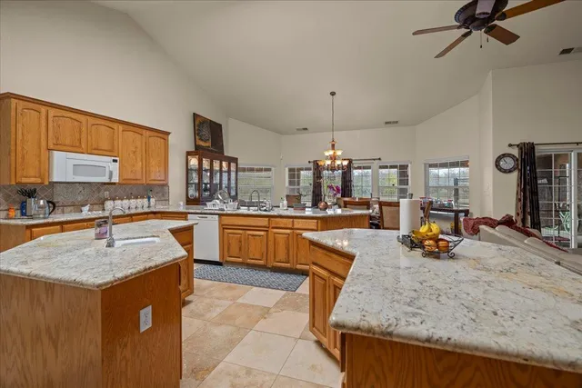 a view of kitchen with sink and refrigerator