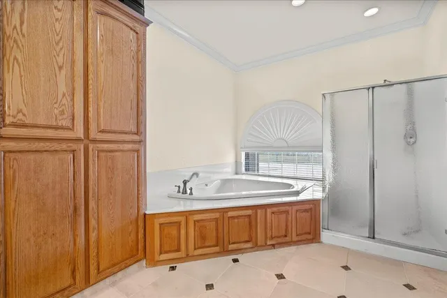 a spacious bathroom with a tub sink and mirror