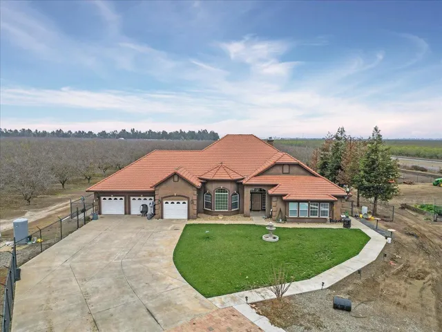 a aerial view of a house with a garden and a pathway