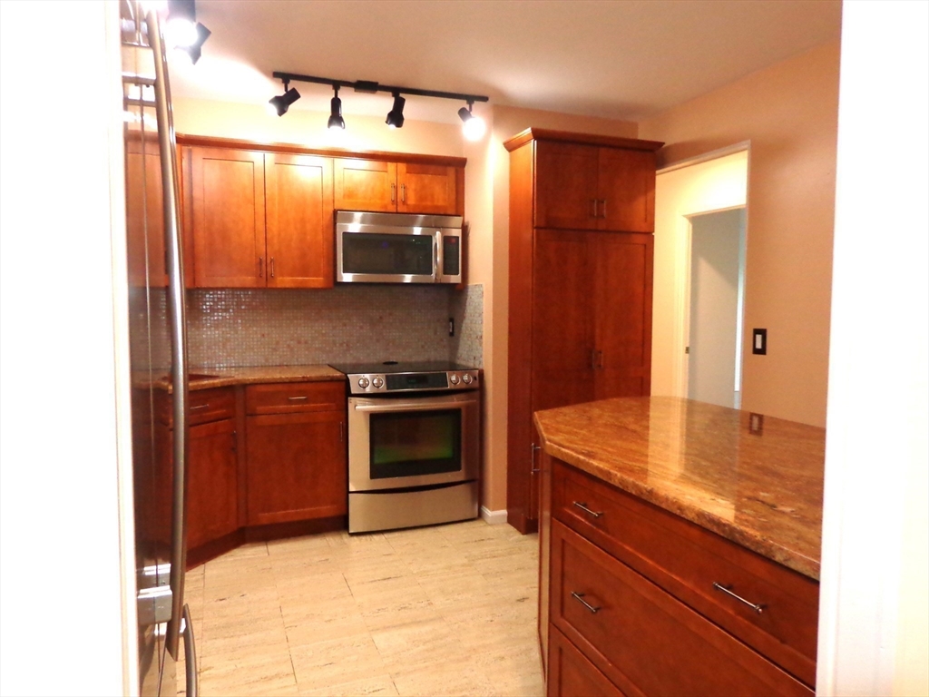 151 Coolidge Avenue, Unit 613 Watertown, MA 02472 - Photo 4 of 16 a kitchen with stainless steel appliances granite countertop a sink and cabinets