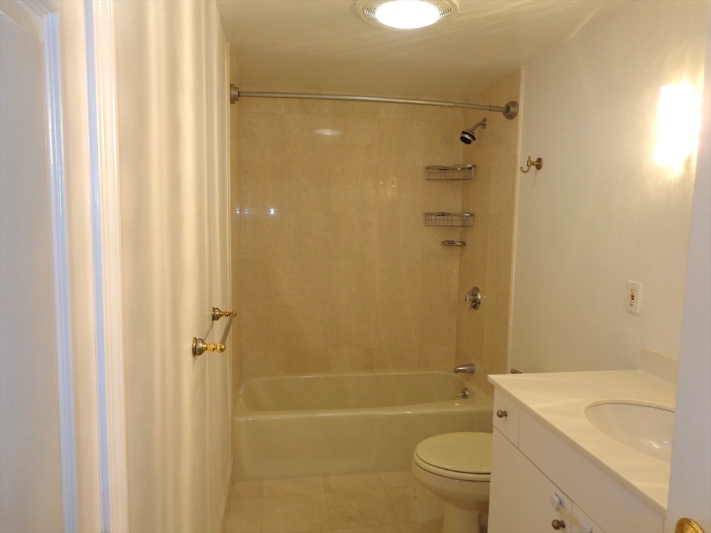 151 Coolidge Avenue, Unit 613 Watertown, MA 02472 - Photo 10 of 16 a bathroom with a sink a toilet and shower