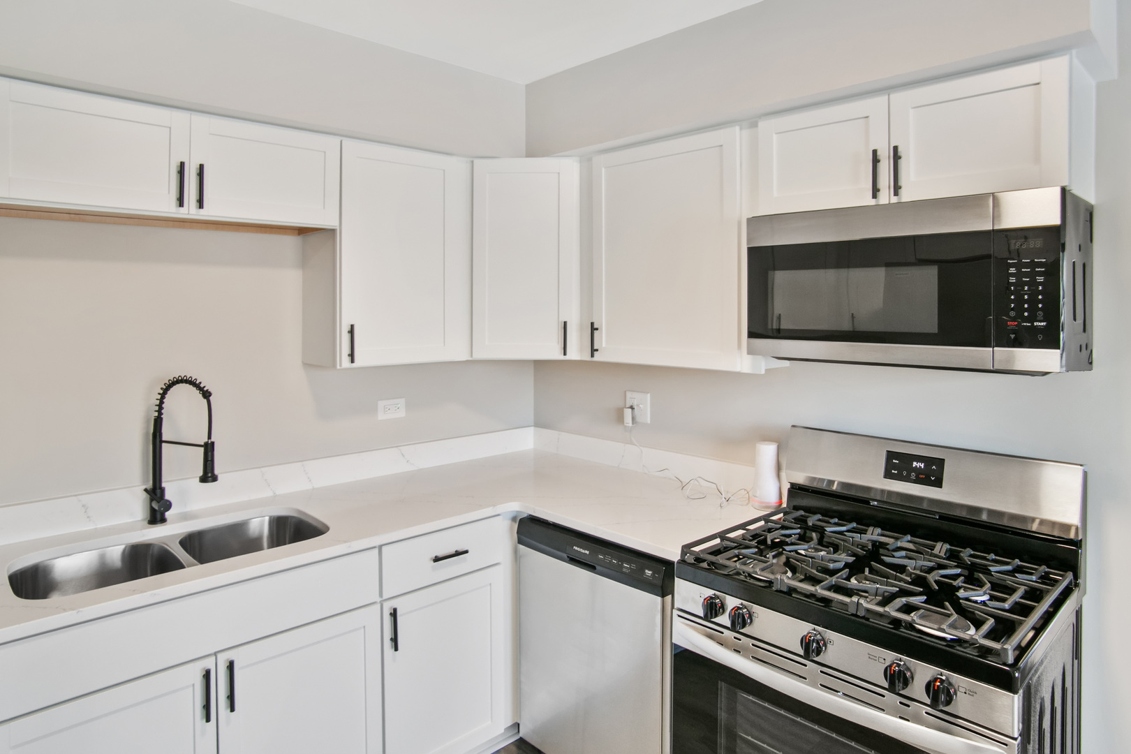 3451 Ithaca Road Olympia Fields, IL 60461 - Photo 7 of 29 a kitchen with stainless steel appliances granite countertop white cabinets a stove top oven and granite counter tops