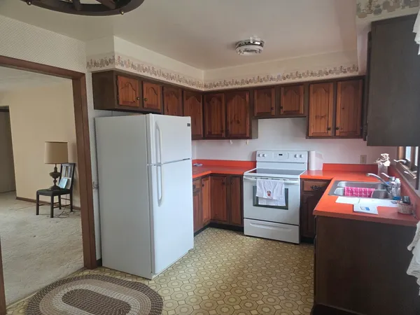 a kitchen with stainless steel appliances a refrigerator sink and cabinets