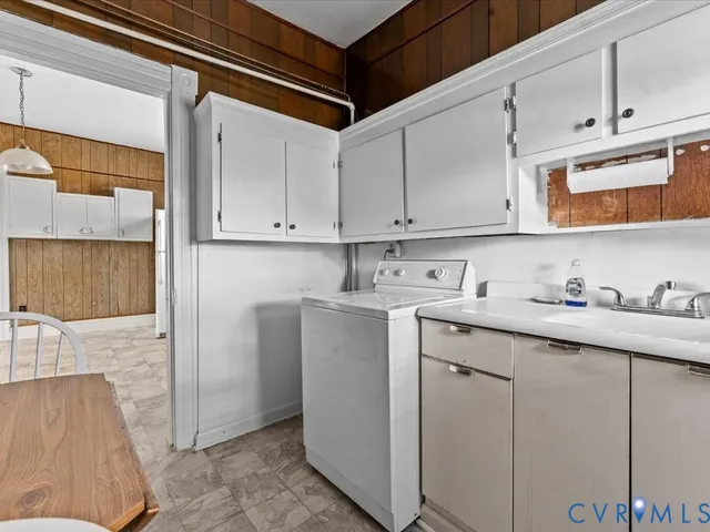 a utility room with cabinets washer and dryer