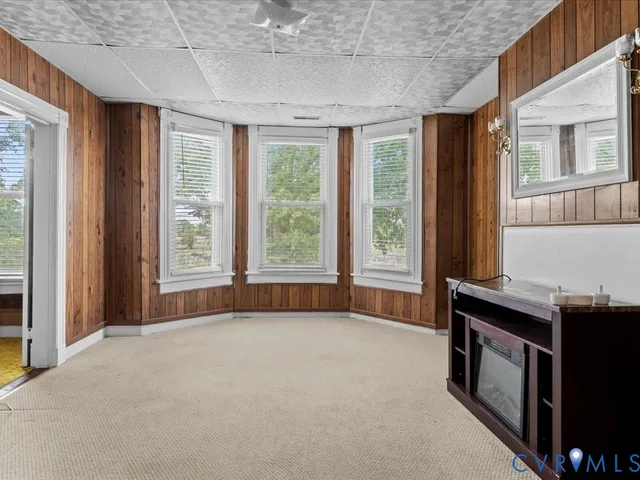 an empty room with windows and closet