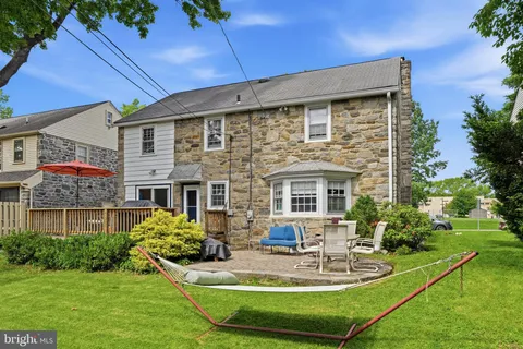 a view of a house with a yard porch and sitting area