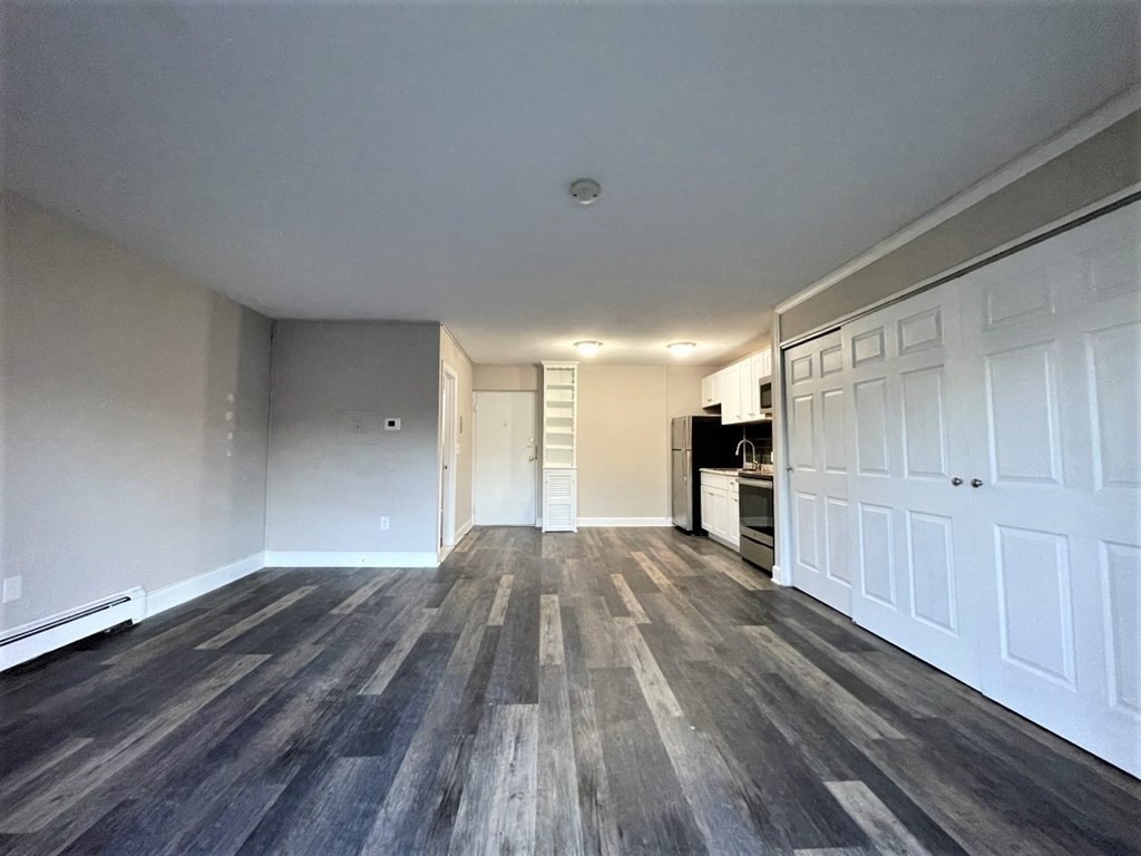 625 Main Street, Unit 10 Reading, MA 01867 - Photo 2 of 5 a view of empty room with wooden floor