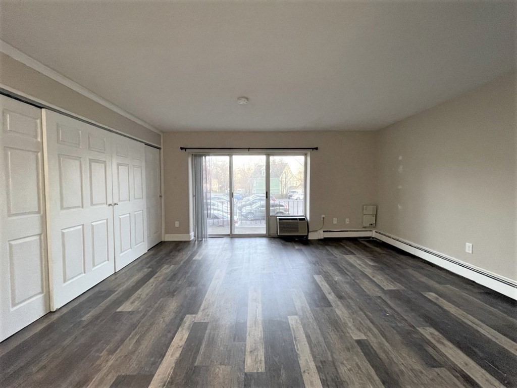 625 Main Street, Unit 10 Reading, MA 01867 - Photo 3 of 5 a view of wooden floor and windows in a room