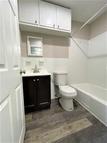 a bathroom with a toilet a sink and bathtub