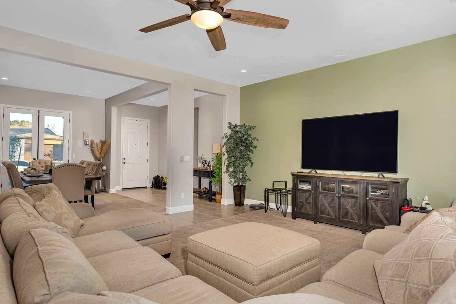 1053 Beaver Pond Loop Madera, CA 93636 - Photo 11 of 81 a living room with furniture and a flat screen tv
