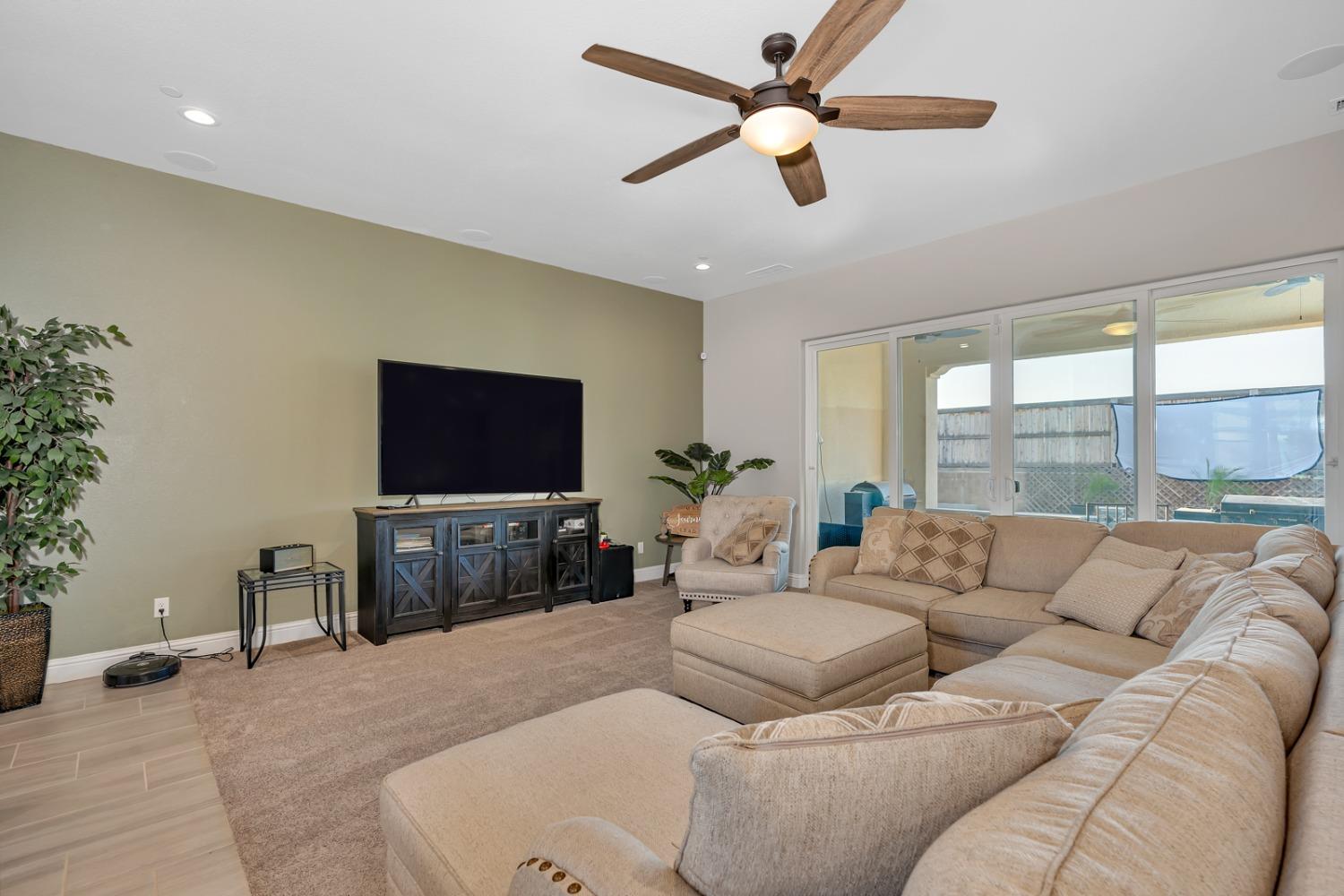 1053 Beaver Pond Loop Madera, CA 93636 - Photo 12 of 81 a living room with furniture and a flat screen tv
