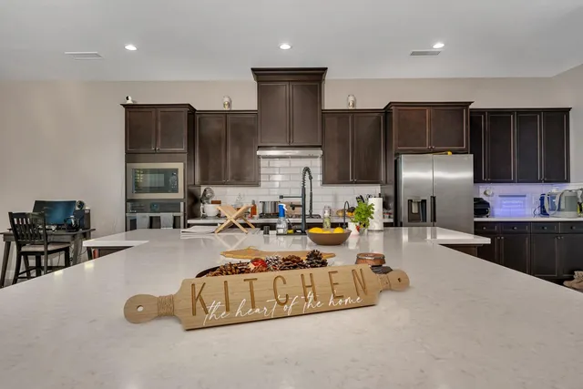 a kitchen with stainless steel appliances granite countertop a refrigerator and a sink