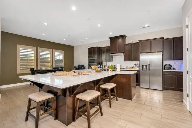 a kitchen with stainless steel appliances granite countertop a refrigerator and a sink