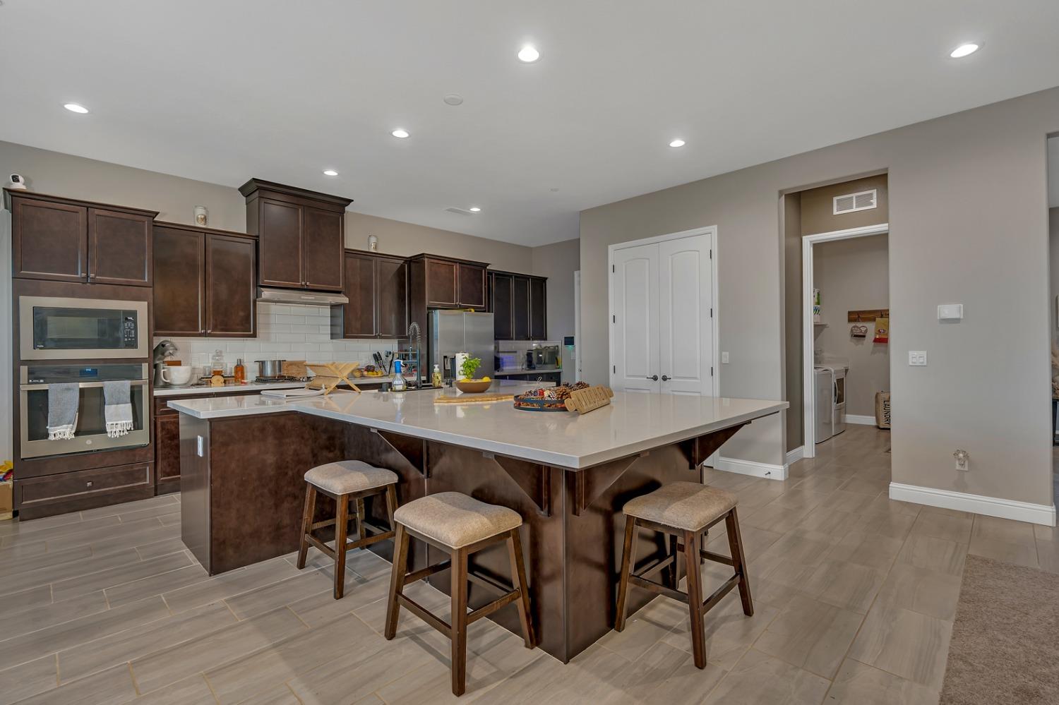 1053 Beaver Pond Loop Madera, CA 93636 - Photo 16 of 81 a kitchen with a table and chairs in it